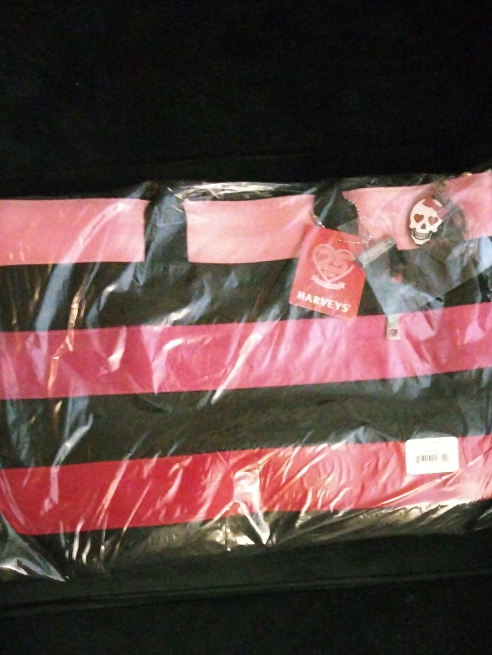 Harveys Black and Pink Striped Seatbelt Tote with Skull Charm
